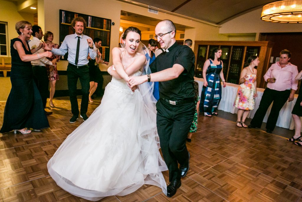 Bride dancing with priest for an article on how to get the wedding photos you want