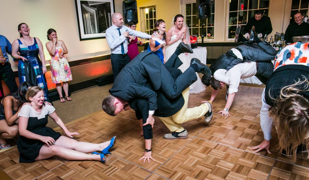 Guests playing games on dance floor at wedding reception