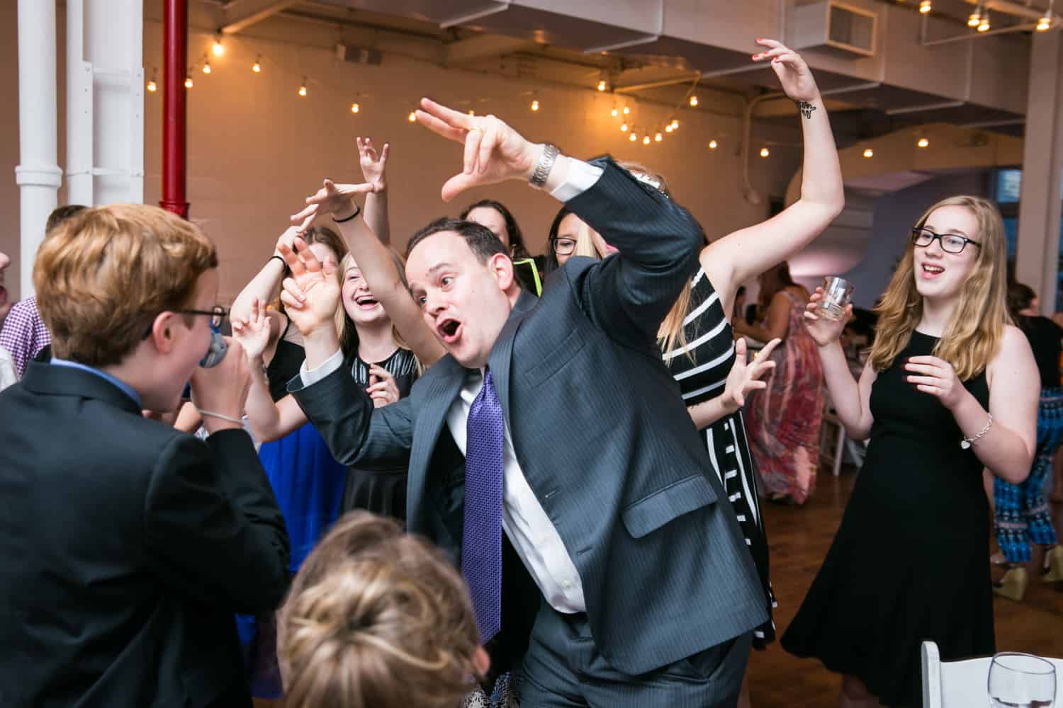 Guests dancing crazy in front of camera for an article on how to plan the perfect bar mitzvah