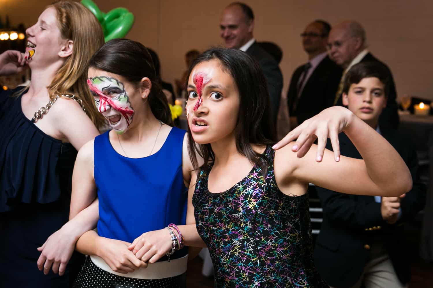 Two girls with zombie face makeup for an article on how to plan the perfect bar mitzvah