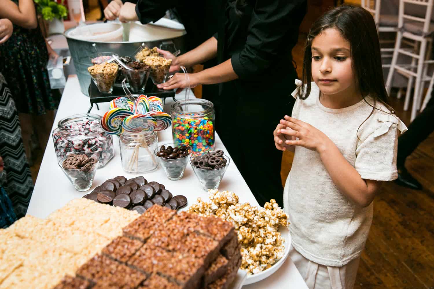 Girl looking at dessert buffet for an article on how to plan the perfect bar mitzvah