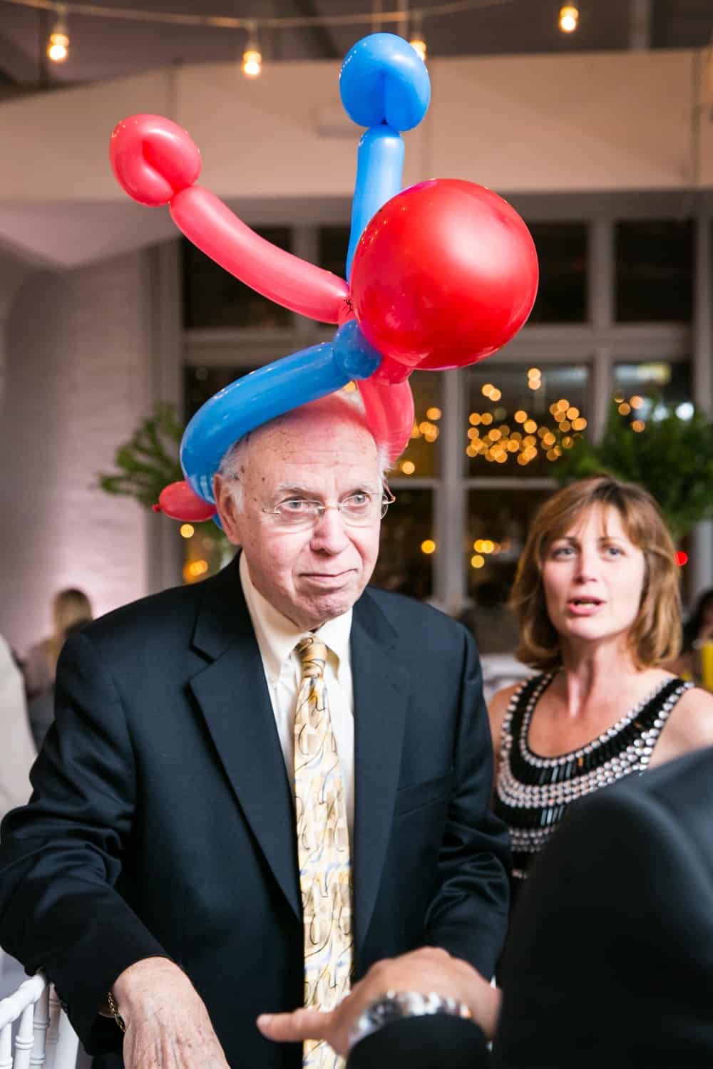 Man wearing red and blue balloon for an article on how to plan the perfect bar mitzvah