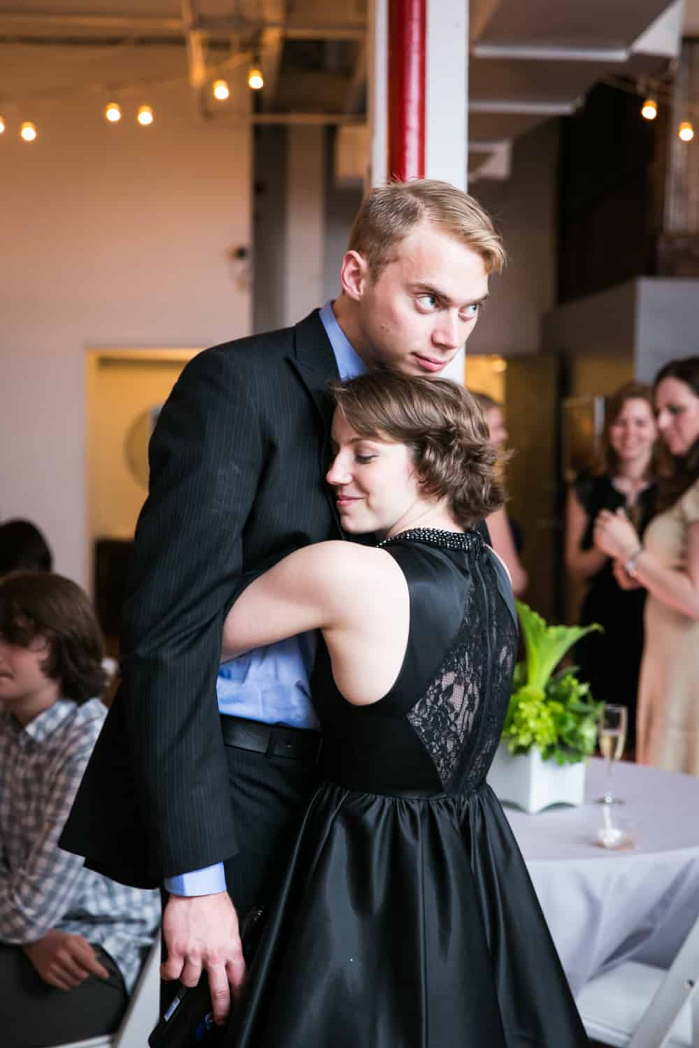 Woman hugging on to man for an article on how to plan the perfect bar mitzvah