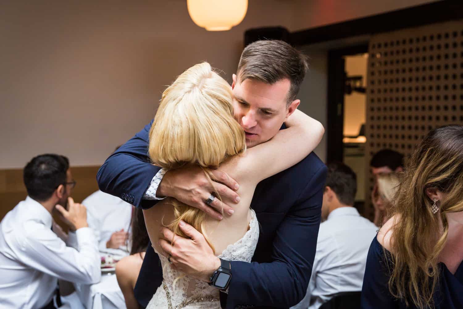 Table shots of bride hugging guest
