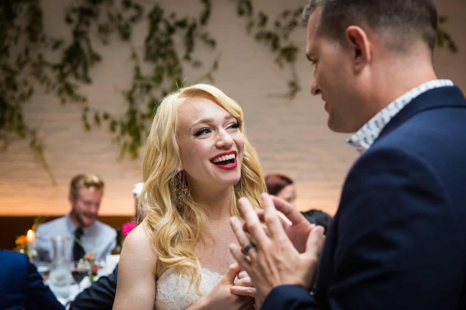 Bride talking with guest during reception