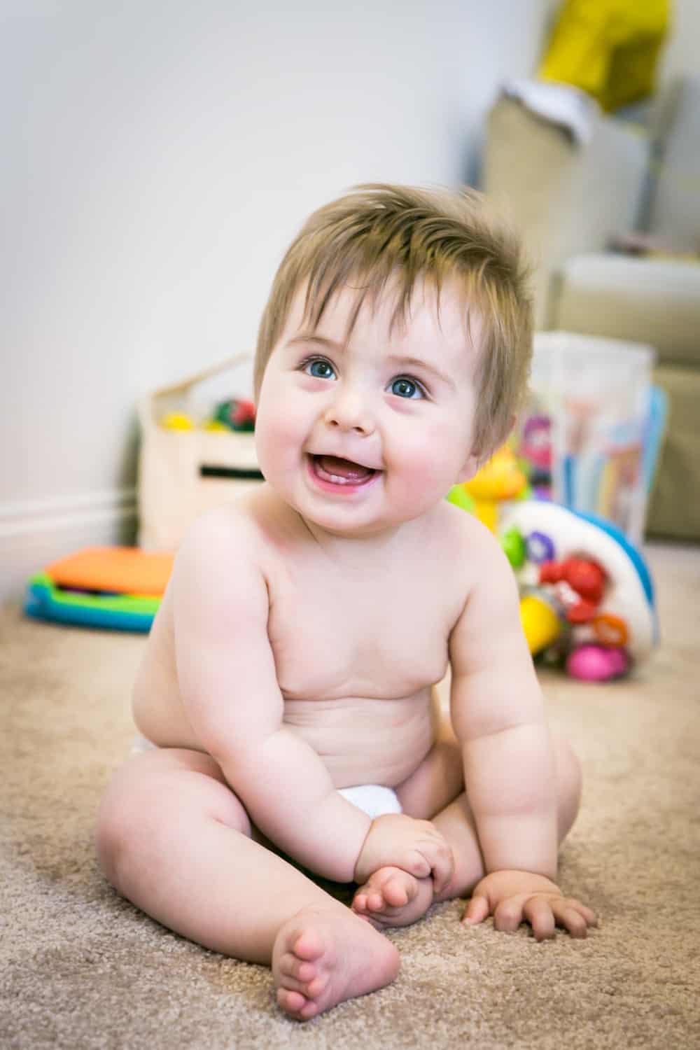 Baby boy wearing diaper on carpet