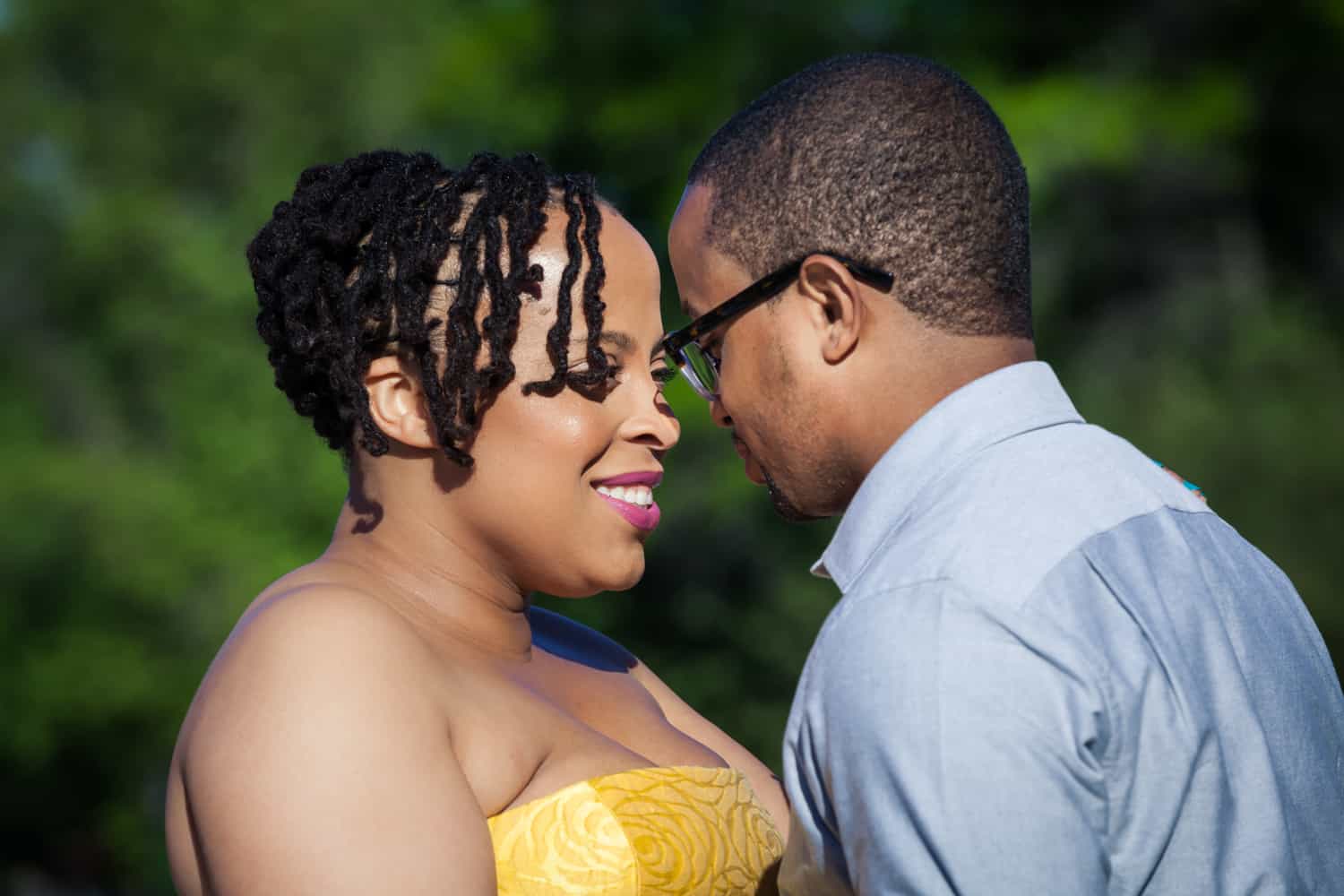 Engaged African American couple touching foreheads
