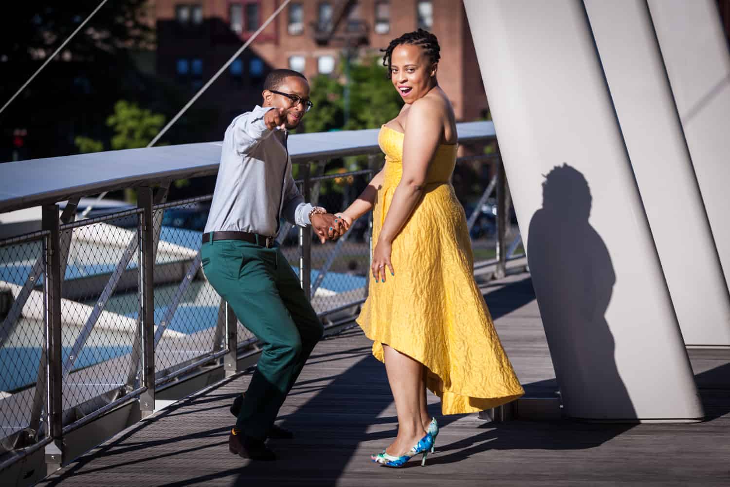 Couple pointing to camera at a Brooklyn Museum engagement shoot