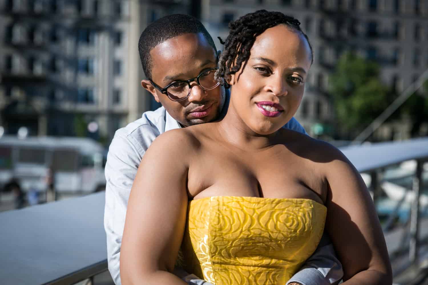 Man hugging woman from behind at a Brooklyn Museum engagement shoot