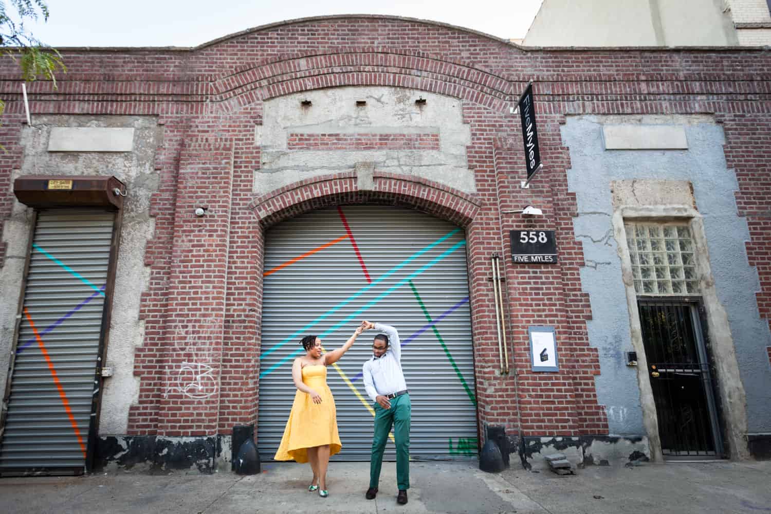 Couple dancing in front of Five Myles gallery in Brooklyn