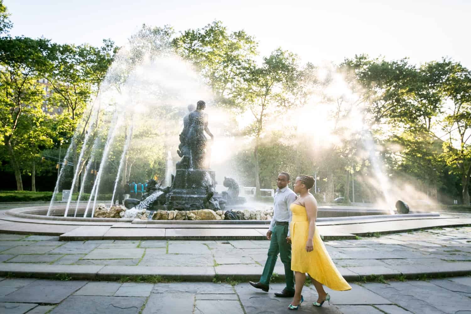 African American couple walking past fountain at Grand Army Plaza