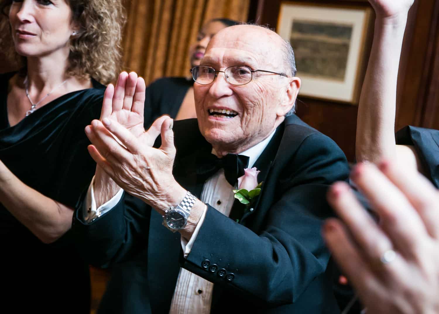 Older man clapping at Harvard Club wedding reception