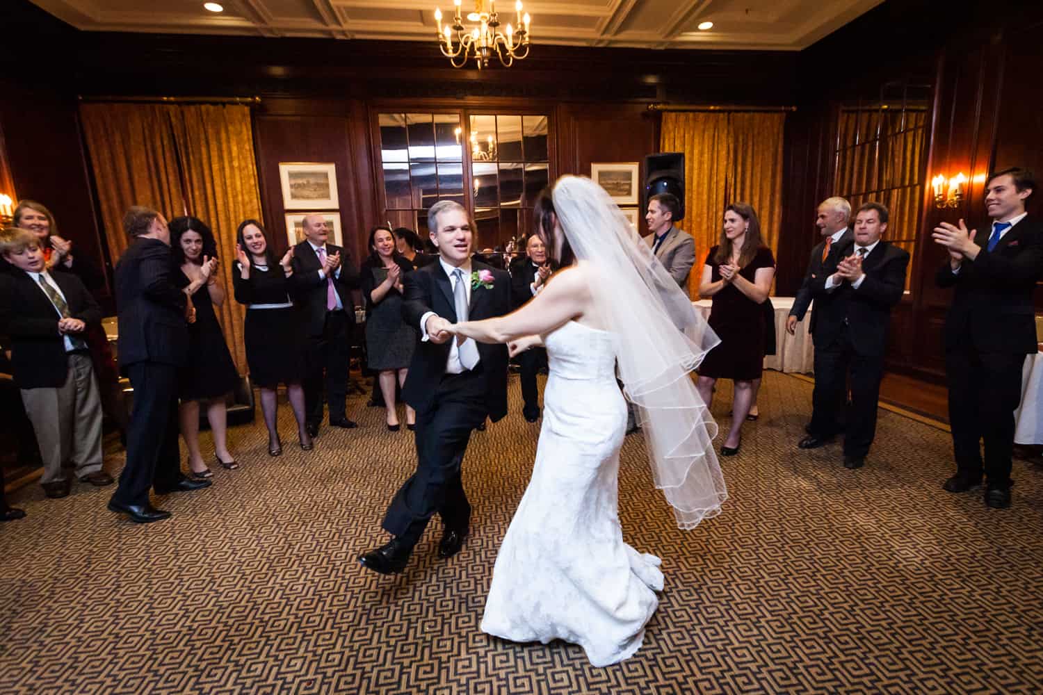 Bride and groom dancing in front of guests for article on the mysteries of photo editing