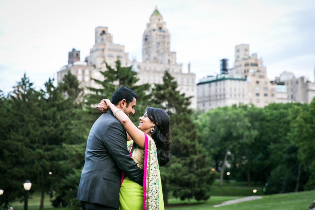 Woman with arms around neck of man in Central Park