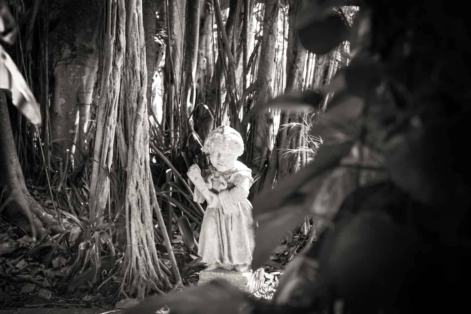 Black and white photo of statue in Ca d'Zan dwarf garden in Sarasota