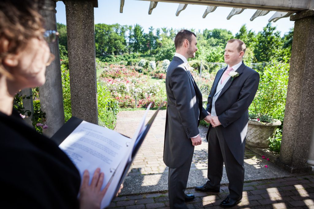 Two grooms exchanging vows at an Brooklyn Botanic Garden wedding