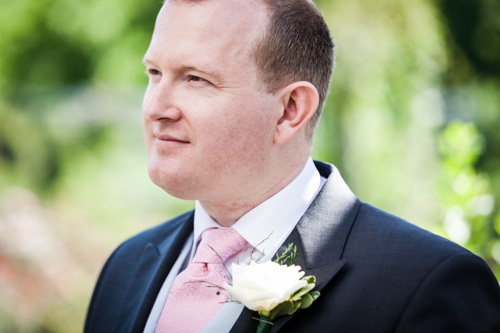Close up on groom with pink tie at an Brooklyn Botanic Garden wedding