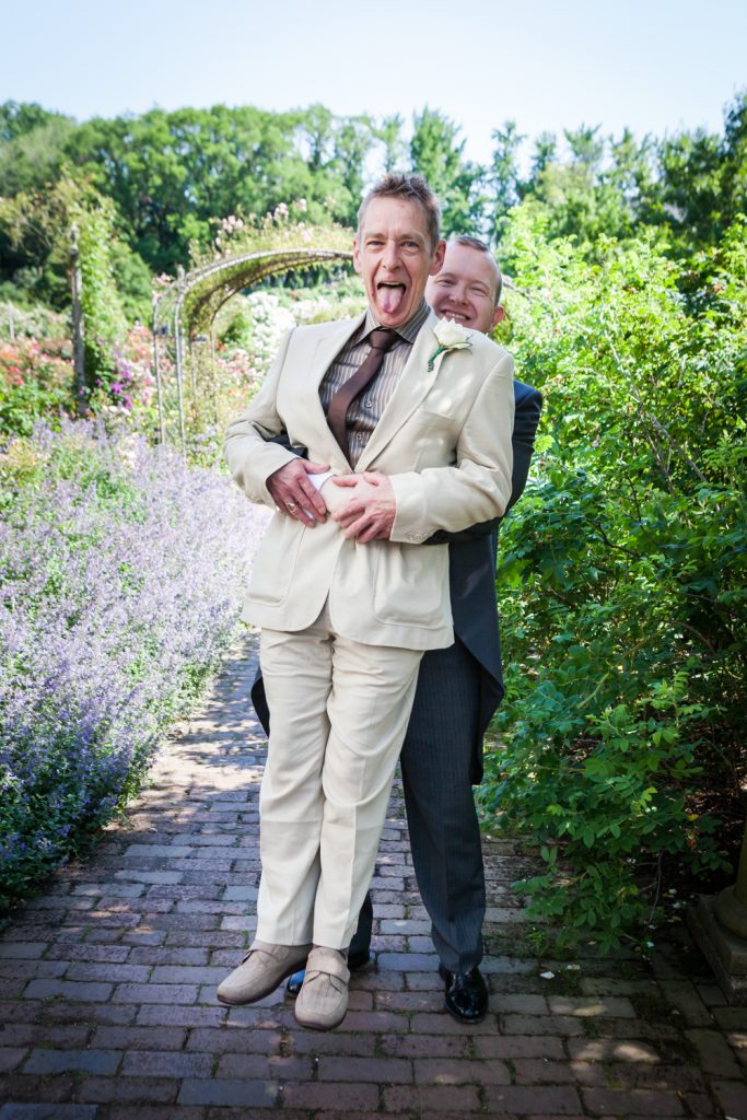Groom picking guest off the ground at an Brooklyn Botanic Garden wedding