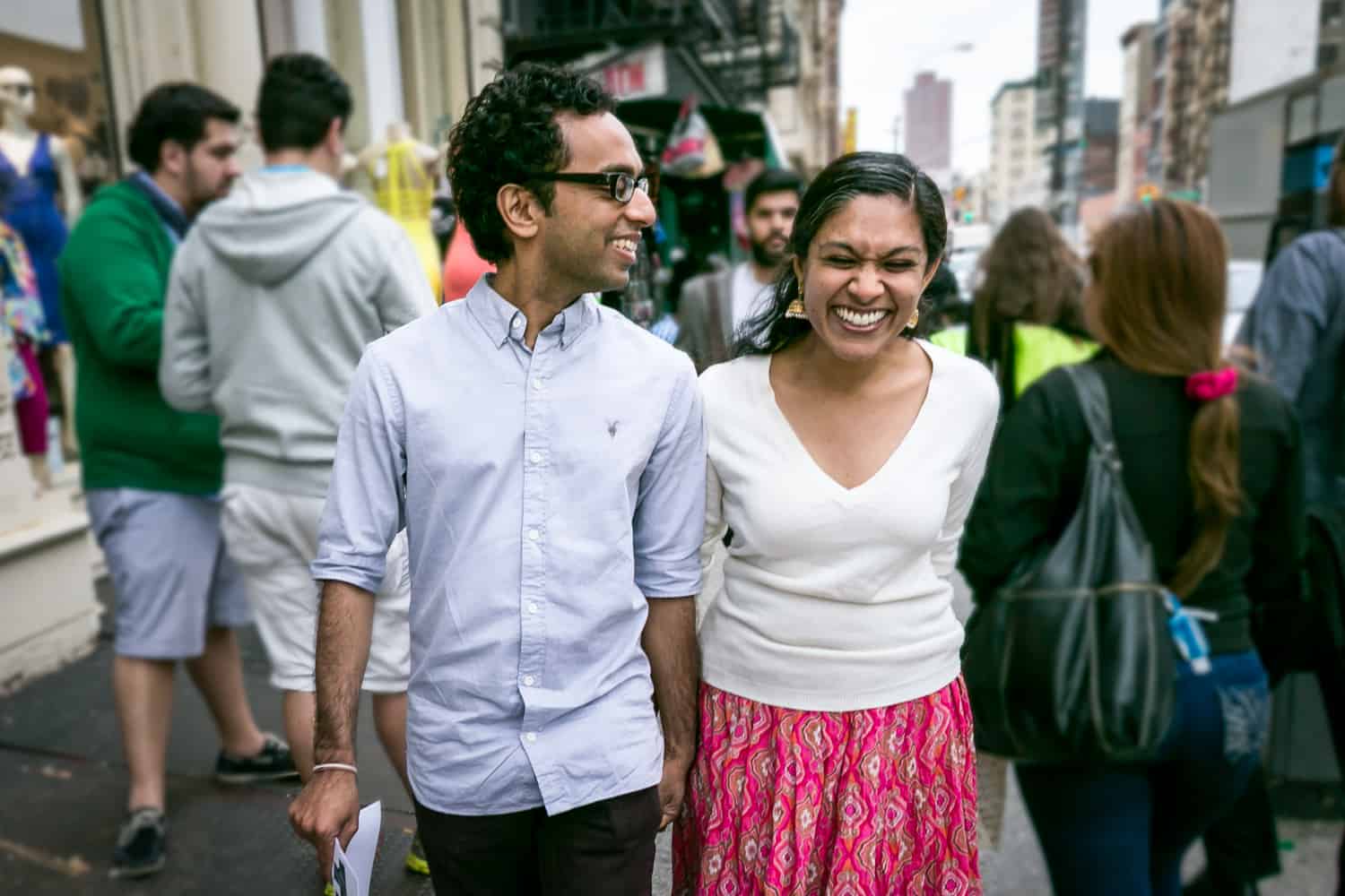 Couple walking on crowded NYC sidewalk