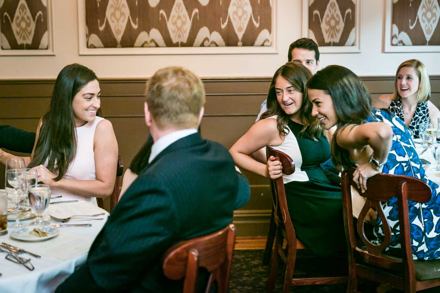 Guests chatting with another table at a Hoboken rehearsal dinner