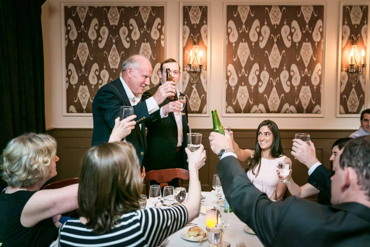 Family making a toast at a table at a Hoboken rehearsal dinner