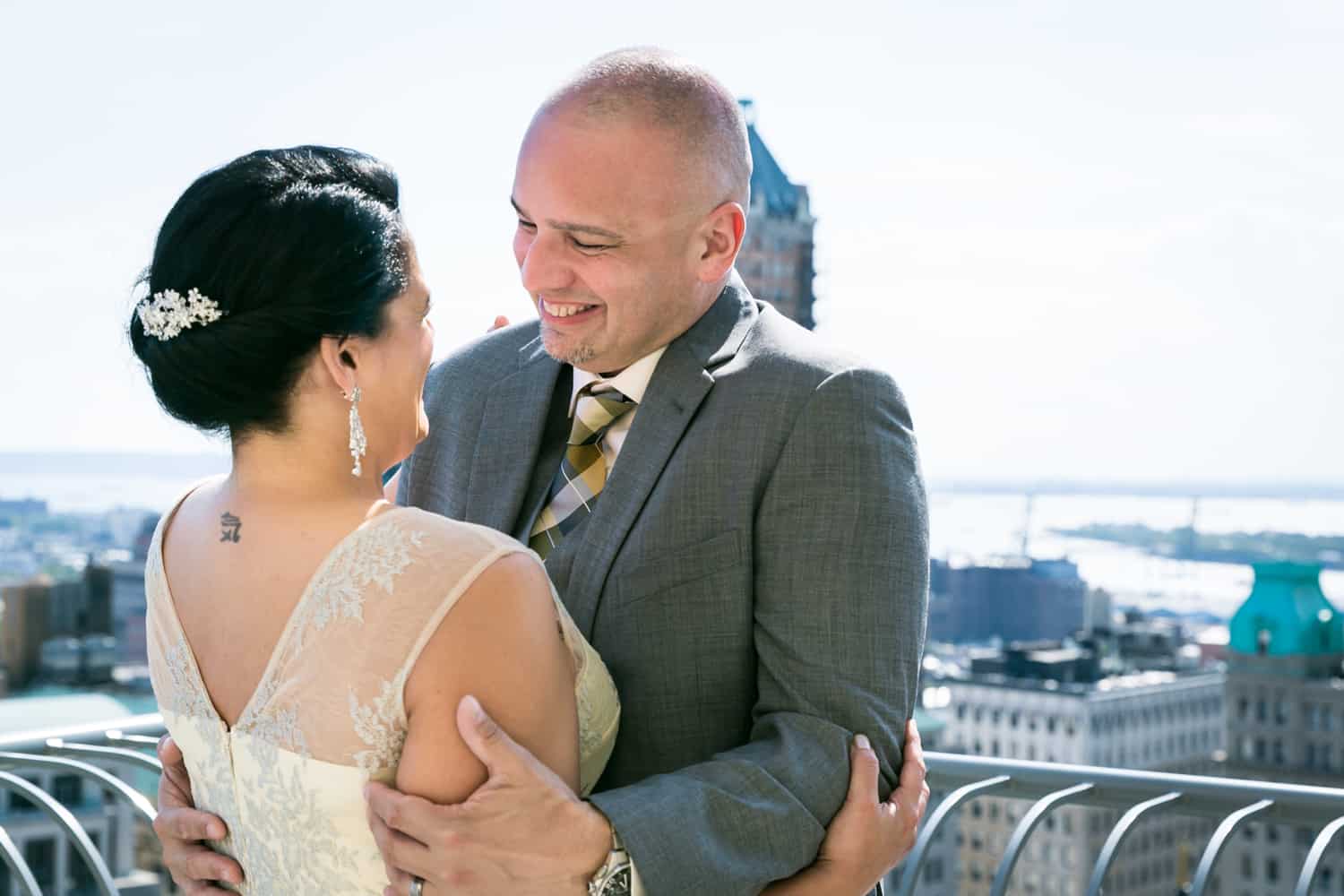 Bride and groom hugging on hotel terrace