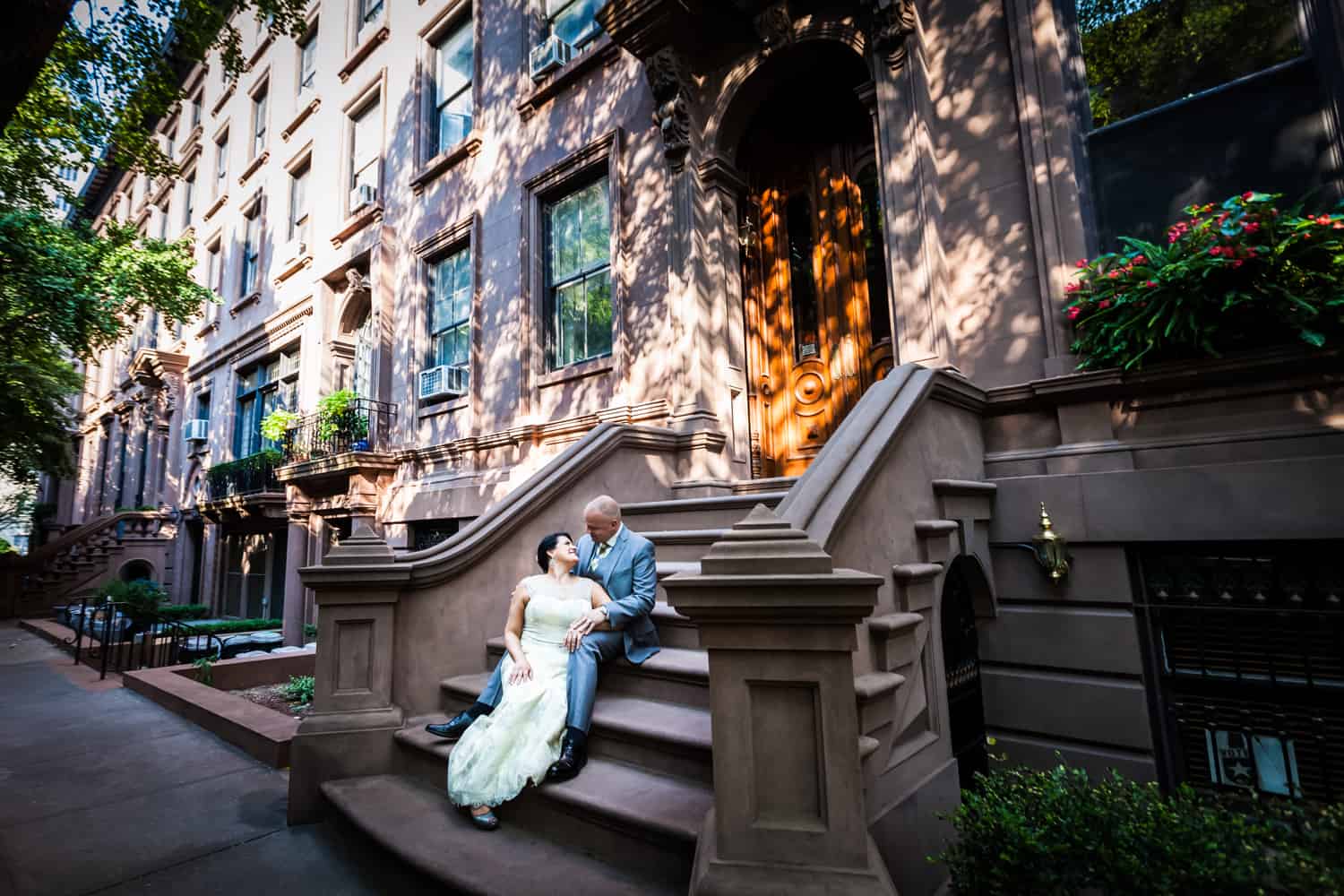 Bride and groom sitting on brownstone steps in Brooklyn Heights