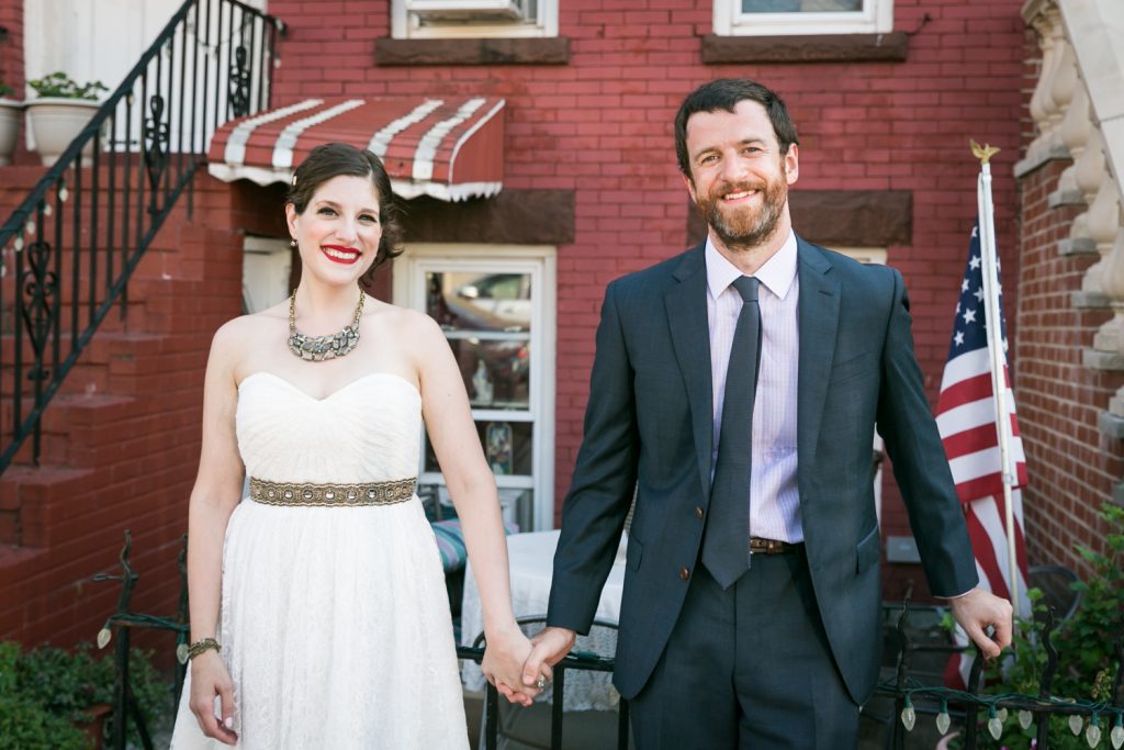Bride and groom in front of brick apartment building in Gowanus