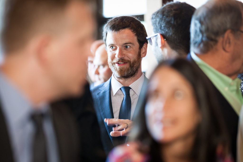 Groom talking to guests at a Bell House wedding anniversary party