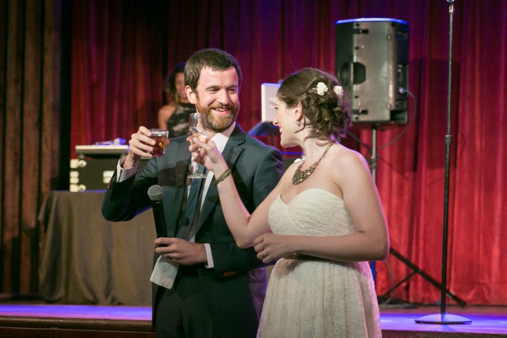 Bride and groom toasting with champagne glasses at a Bell House wedding anniversary party