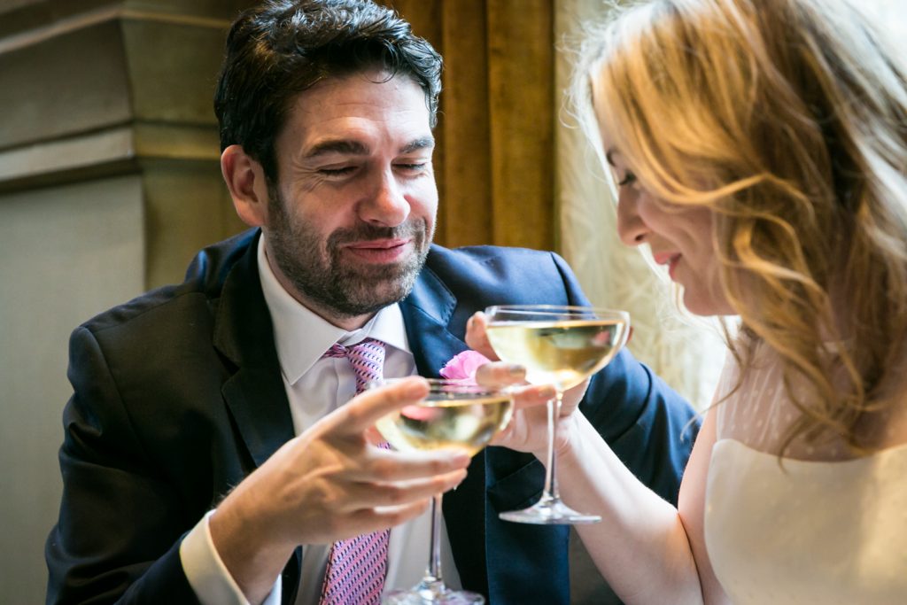 Bride and groom toasting with champagne glasses in Soho Grand Hotel