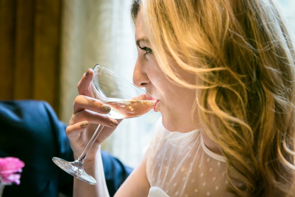 Close up on bride drinking champagne