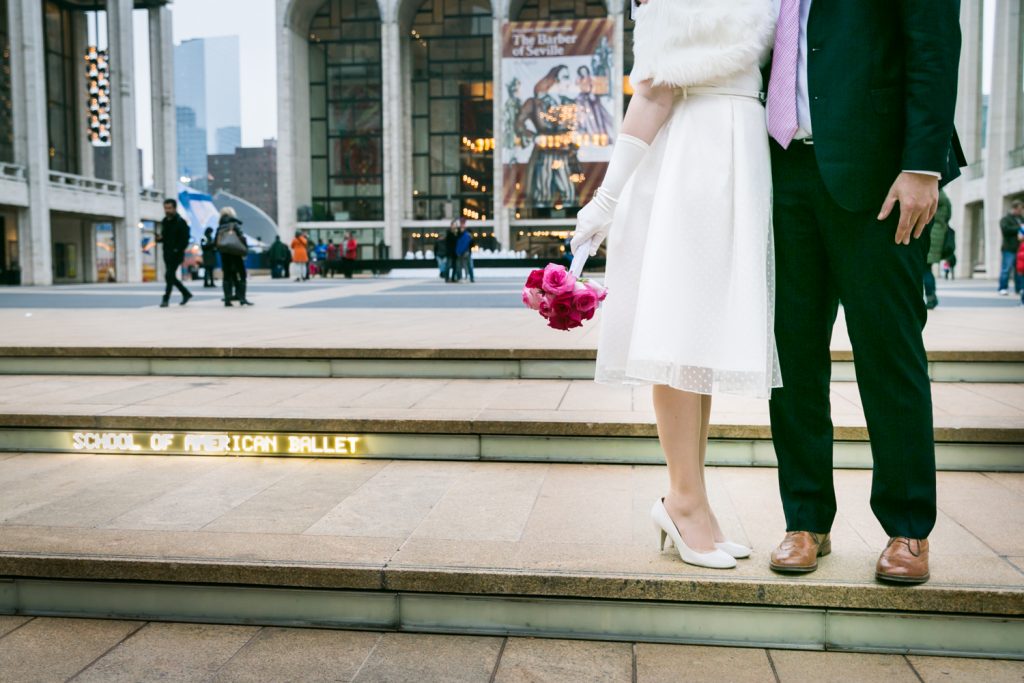 Lincoln Center steps with legs of bride and groom to the right