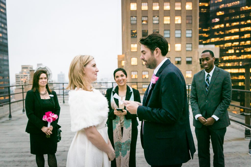 Groom saying vows to bride at a Grand Hyatt Hotel rooftop wedding