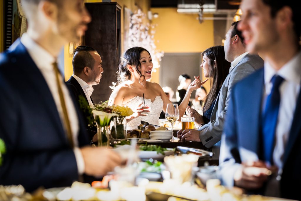 Bride and guests chatting at table at an Astoria restaurant wedding