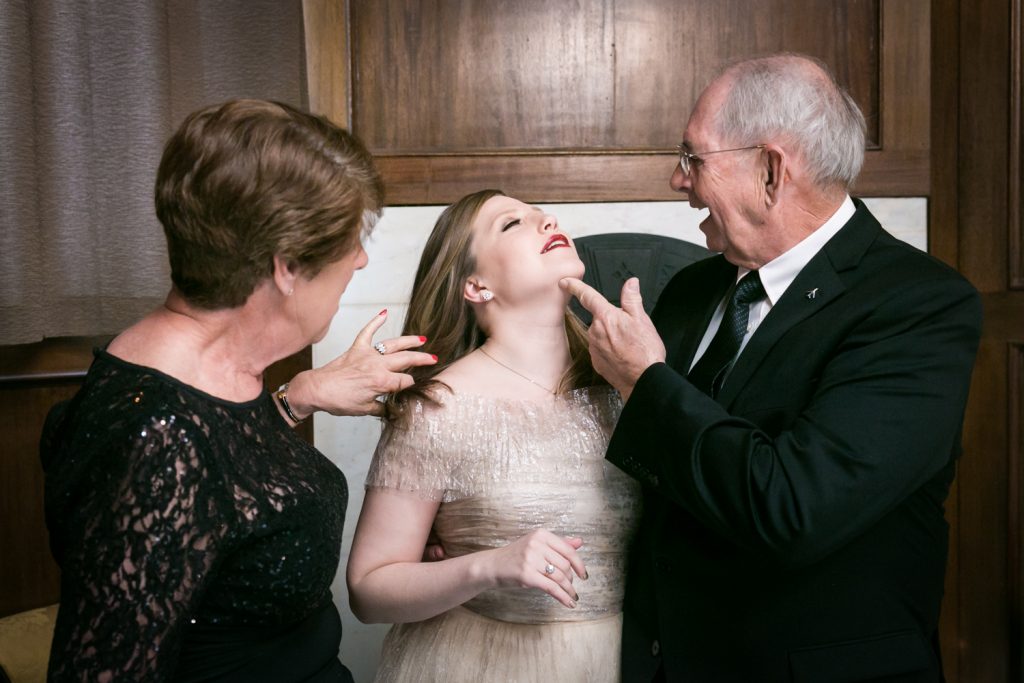 Grandparents touching bride before wedding