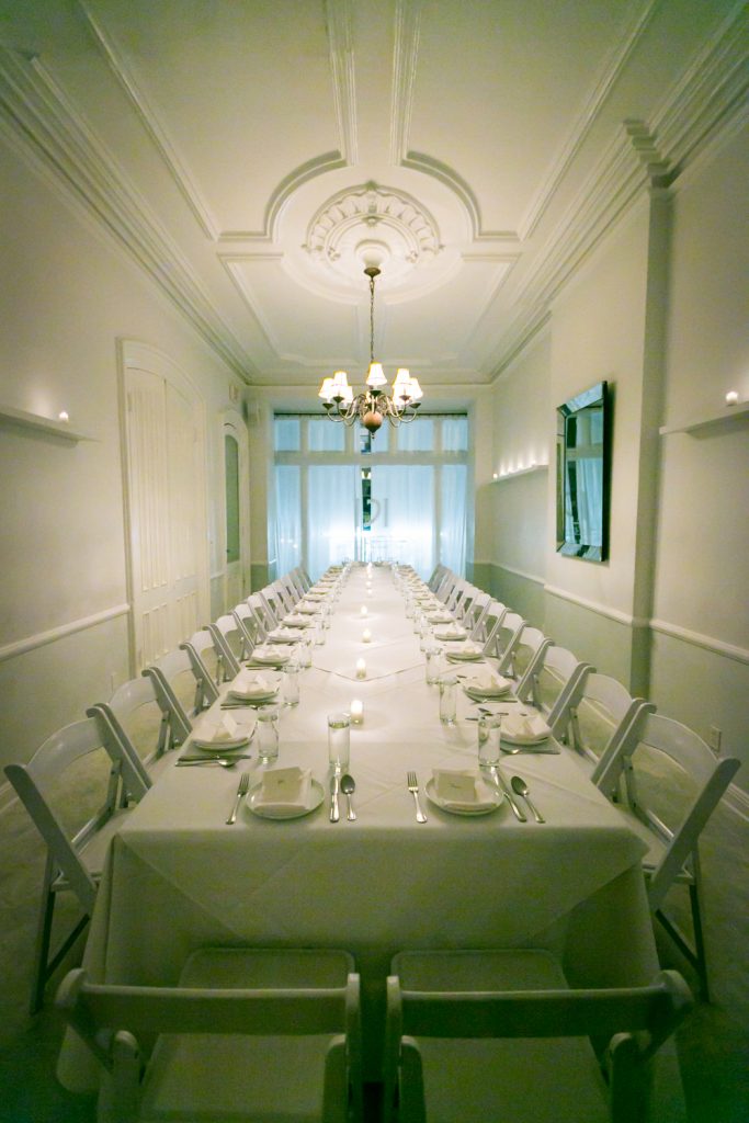 Wide shot of private dining room at Maison May restaurant