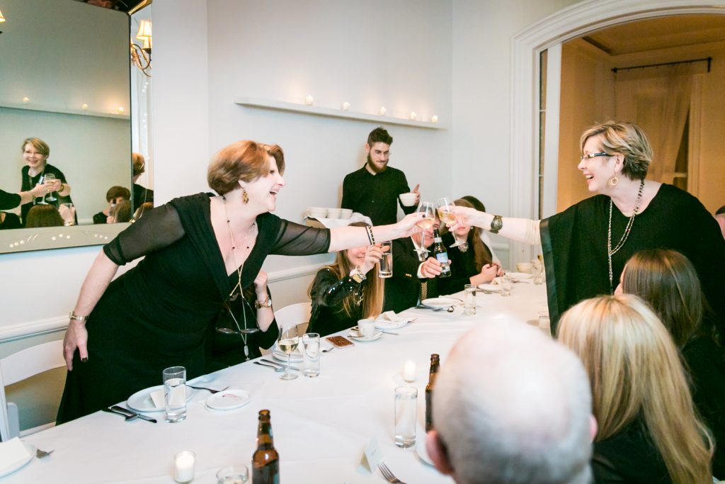 Guests cheering wine glasses during Maison May wedding reception