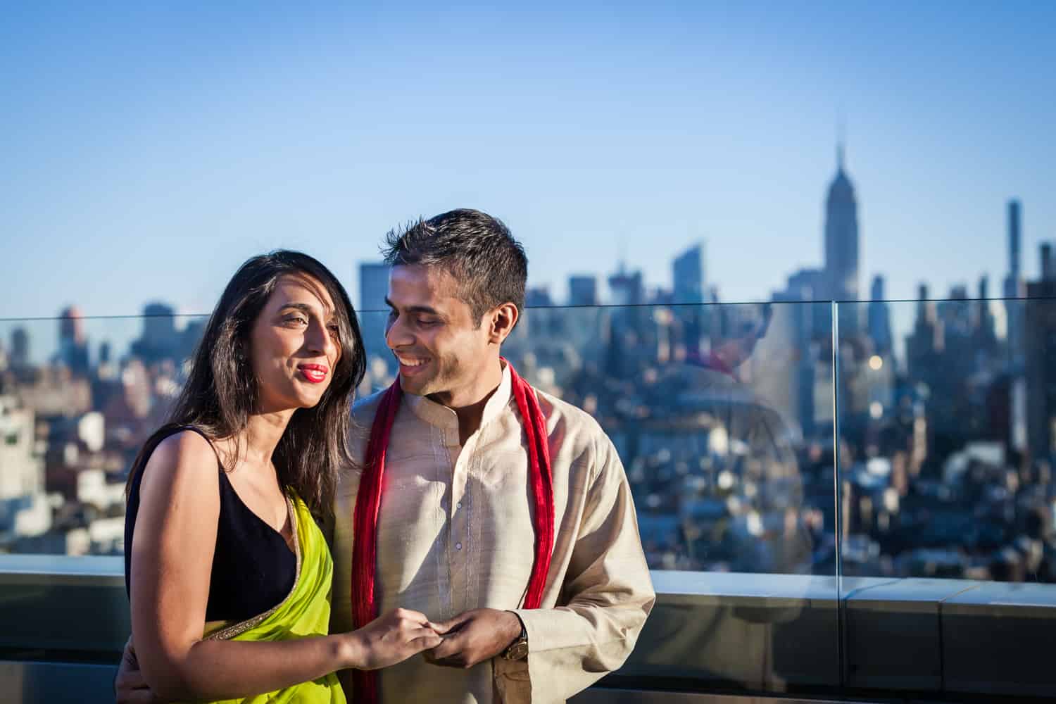 Engaged couple on rooftop wearing traditional Indian attire for an article entitled,' How I get clients comfortable in front of the camera' 