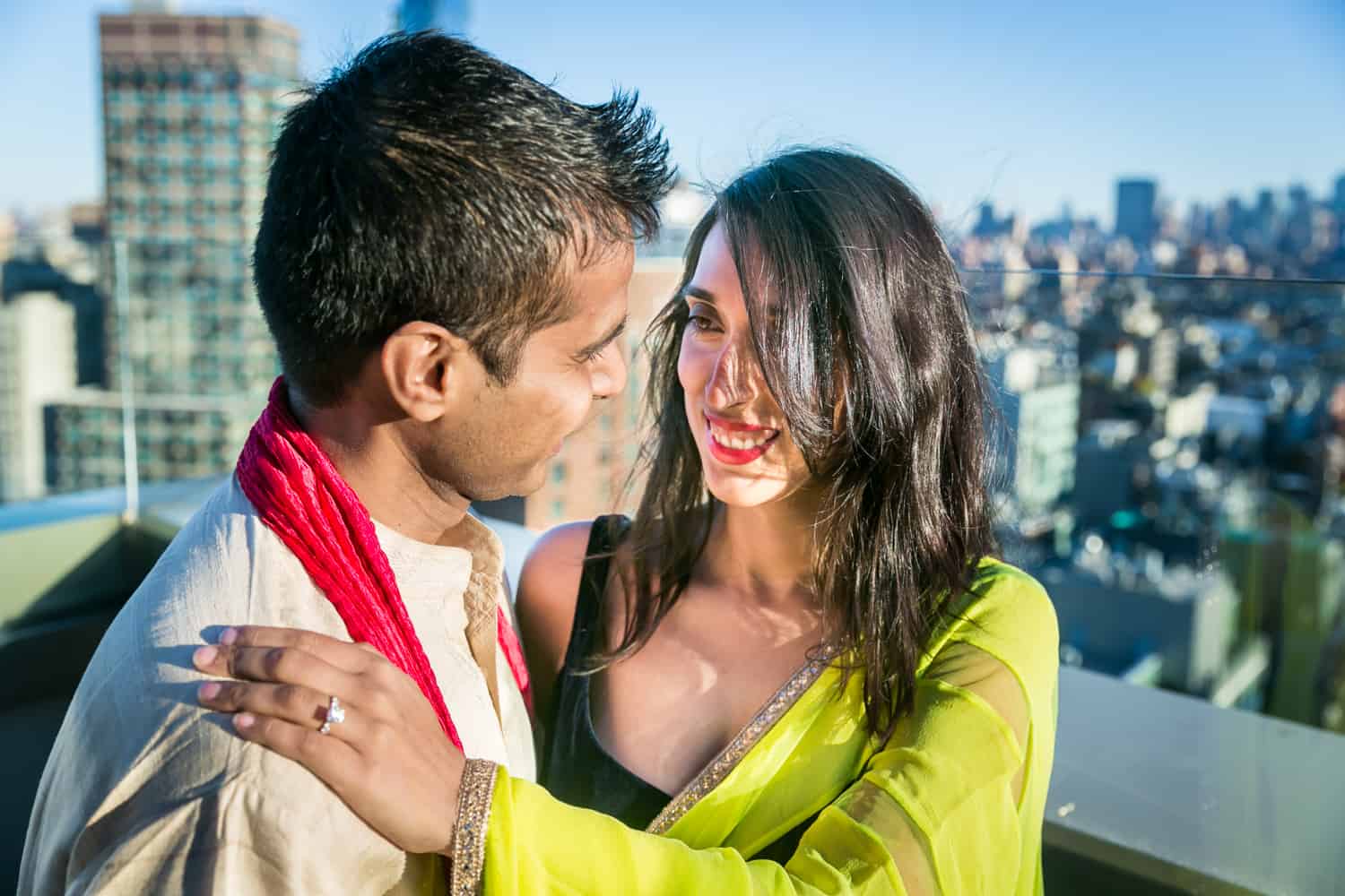 Engaged couple on rooftop wearing traditional Indian attire for an article entitled,' How I get clients comfortable in front of the camera' 