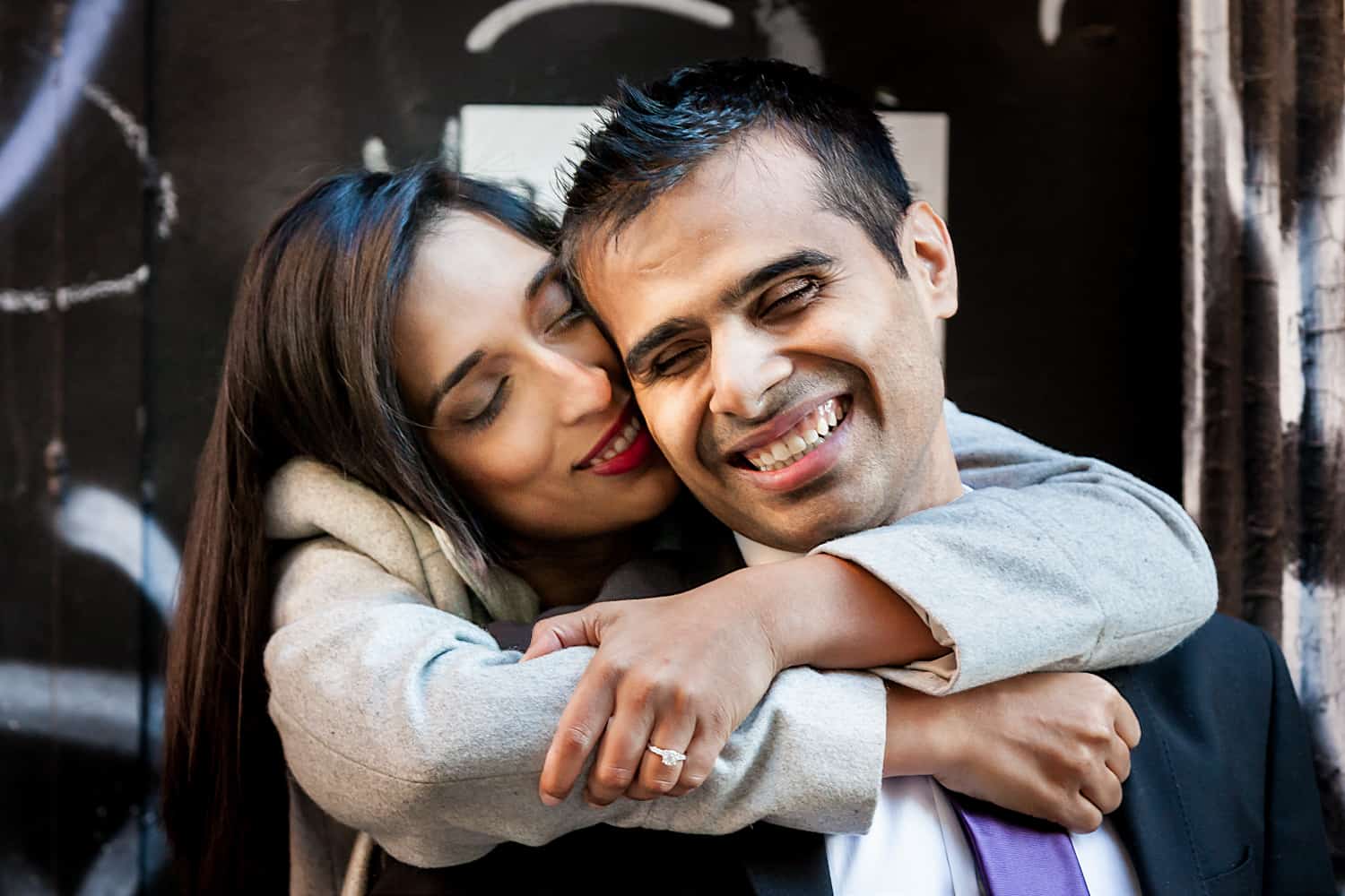 Woman hugging man with arms around neck for an article entitled,' How I get clients comfortable in front of the camera' 