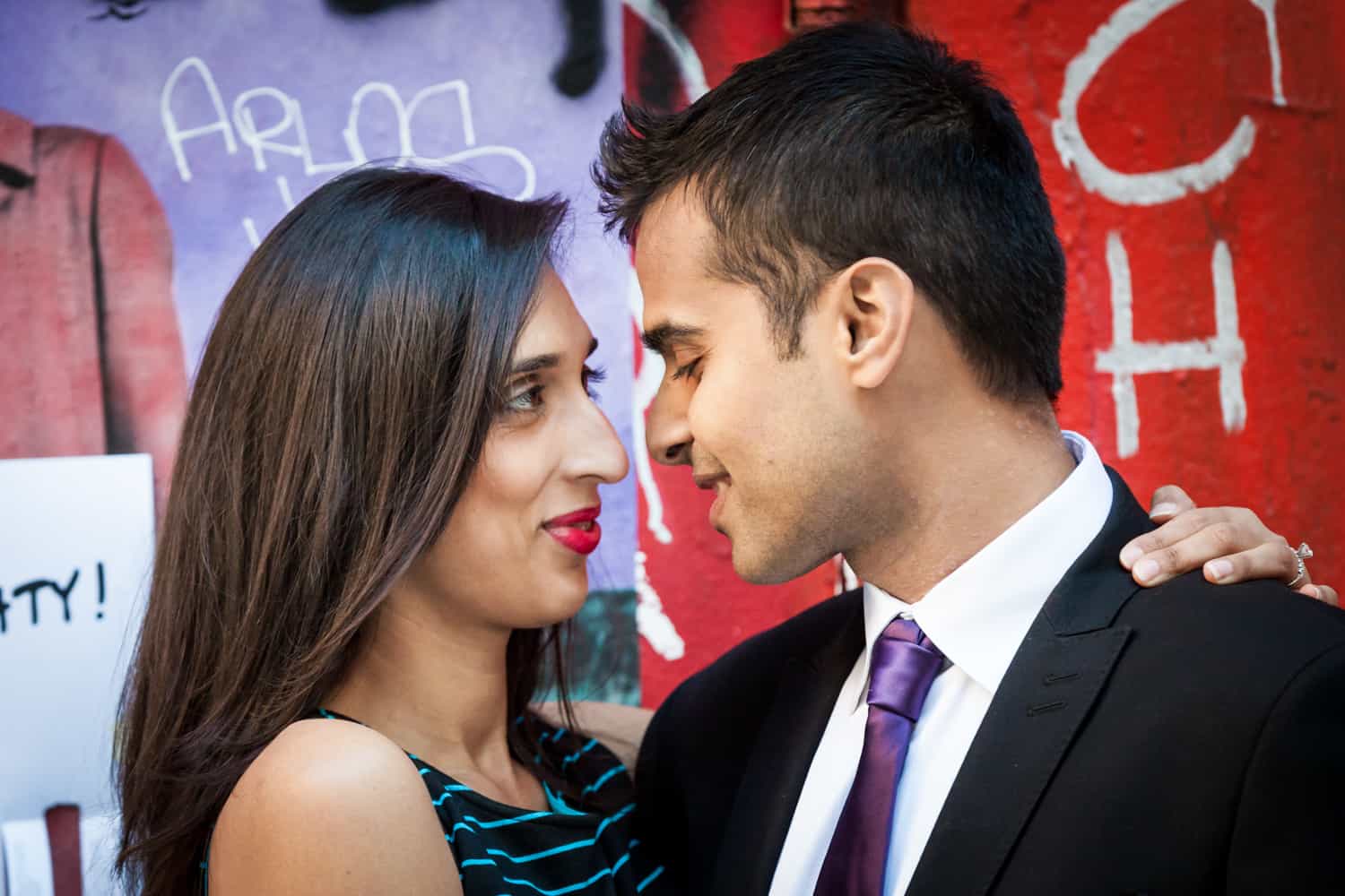 Couple in front of red graffiti wall in Tribeca