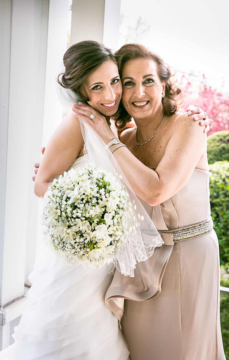 Mother and bride hugging on porch for an article called 'Do you need a second photographer?'