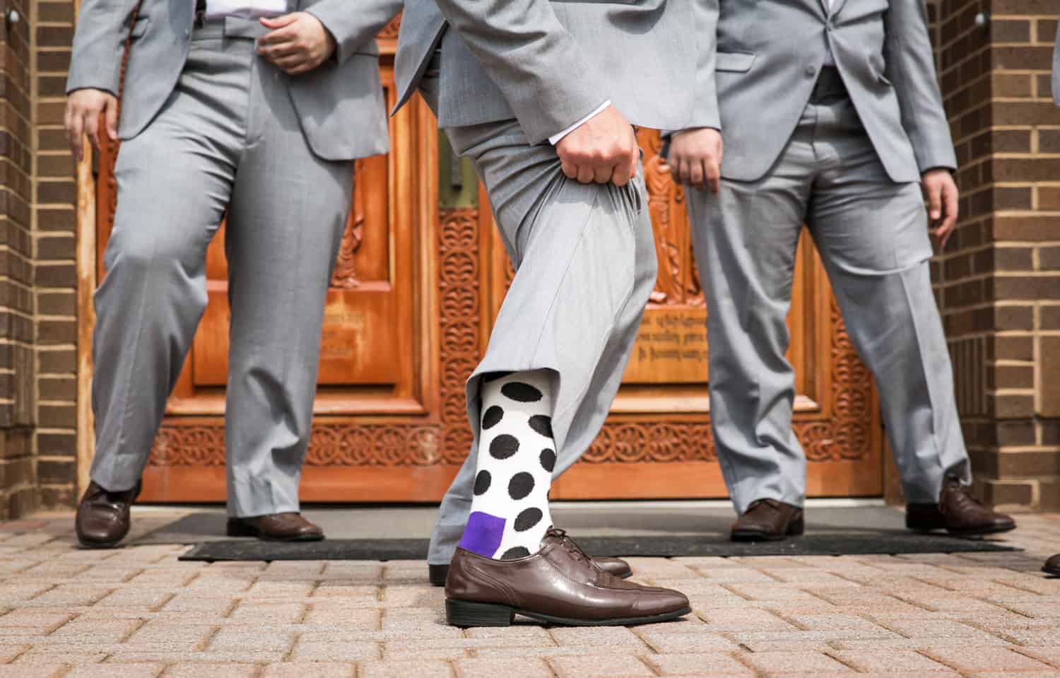 Close up of groomsmen showing off fancy socks