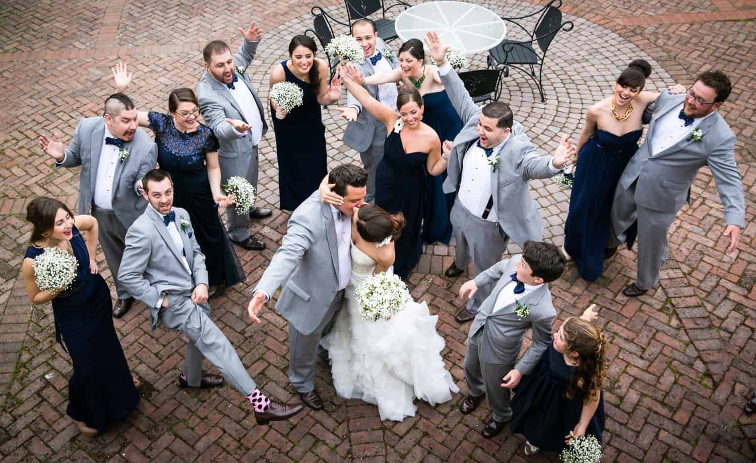 View down on bridal party cheering bride and groom dancing