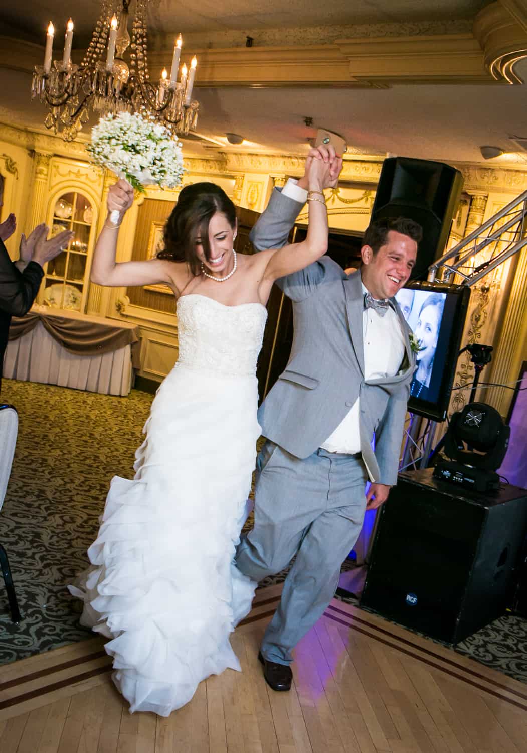 Bride and groom dancing as they enter reception
