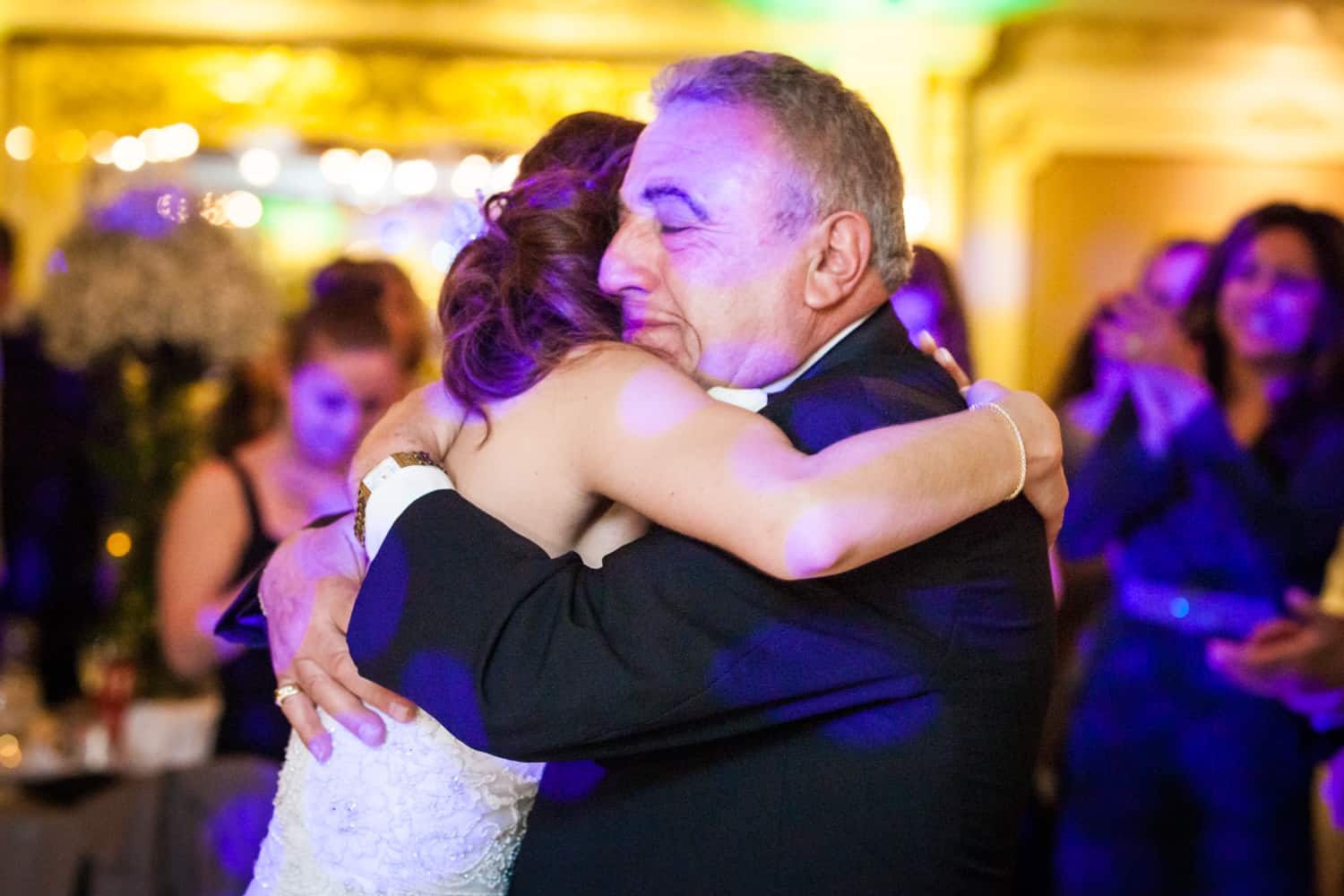 Father hugging bride during Manor wedding reception