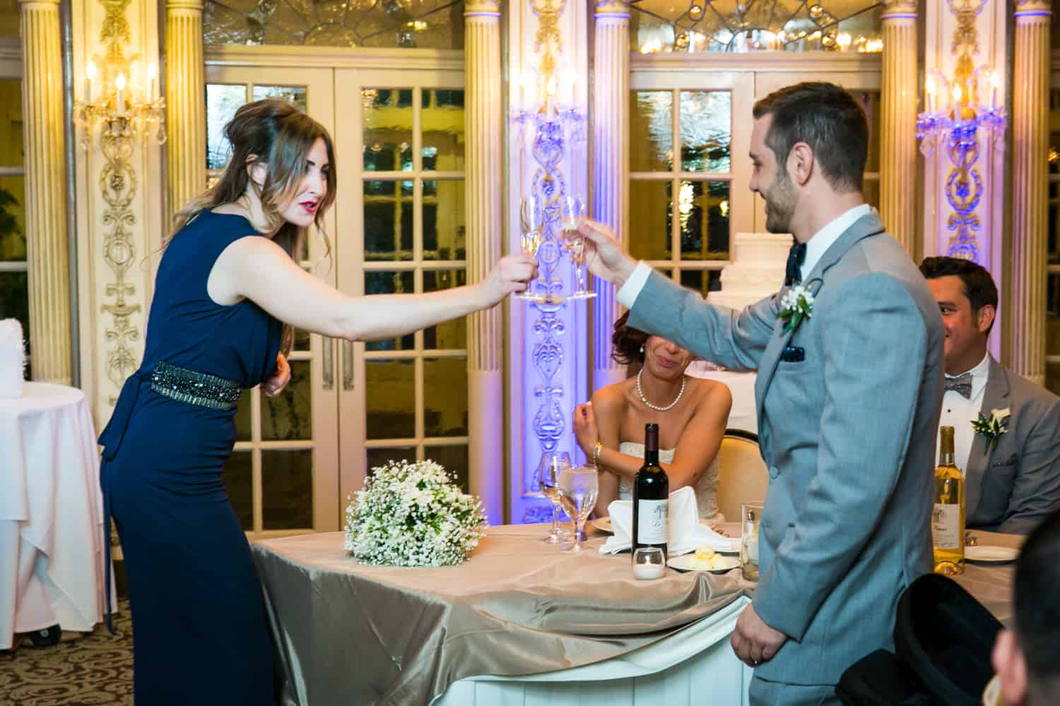 Best man and maid of honor toasting champagne glasses