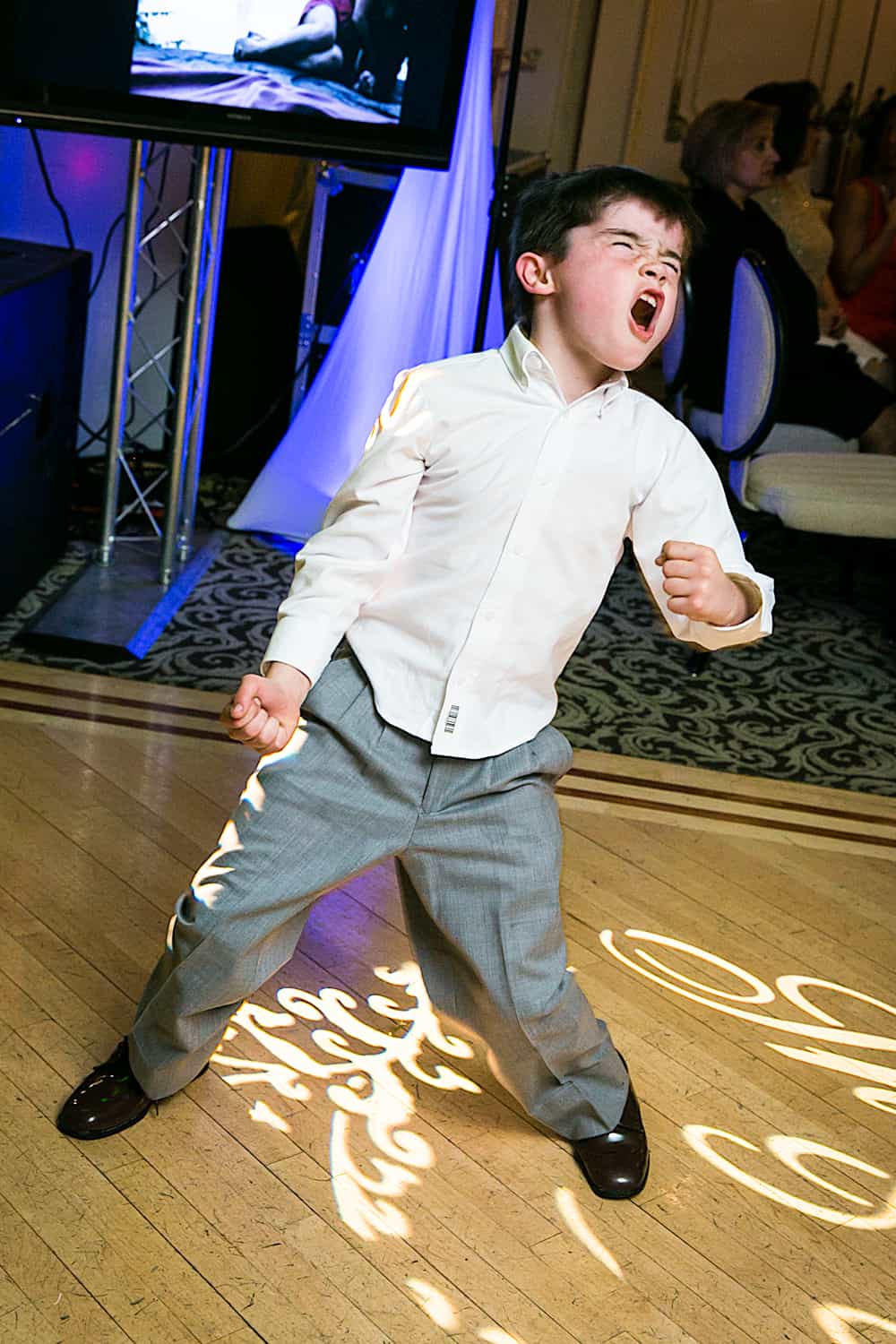 Little boy dancing wildly during Manor wedding reception
