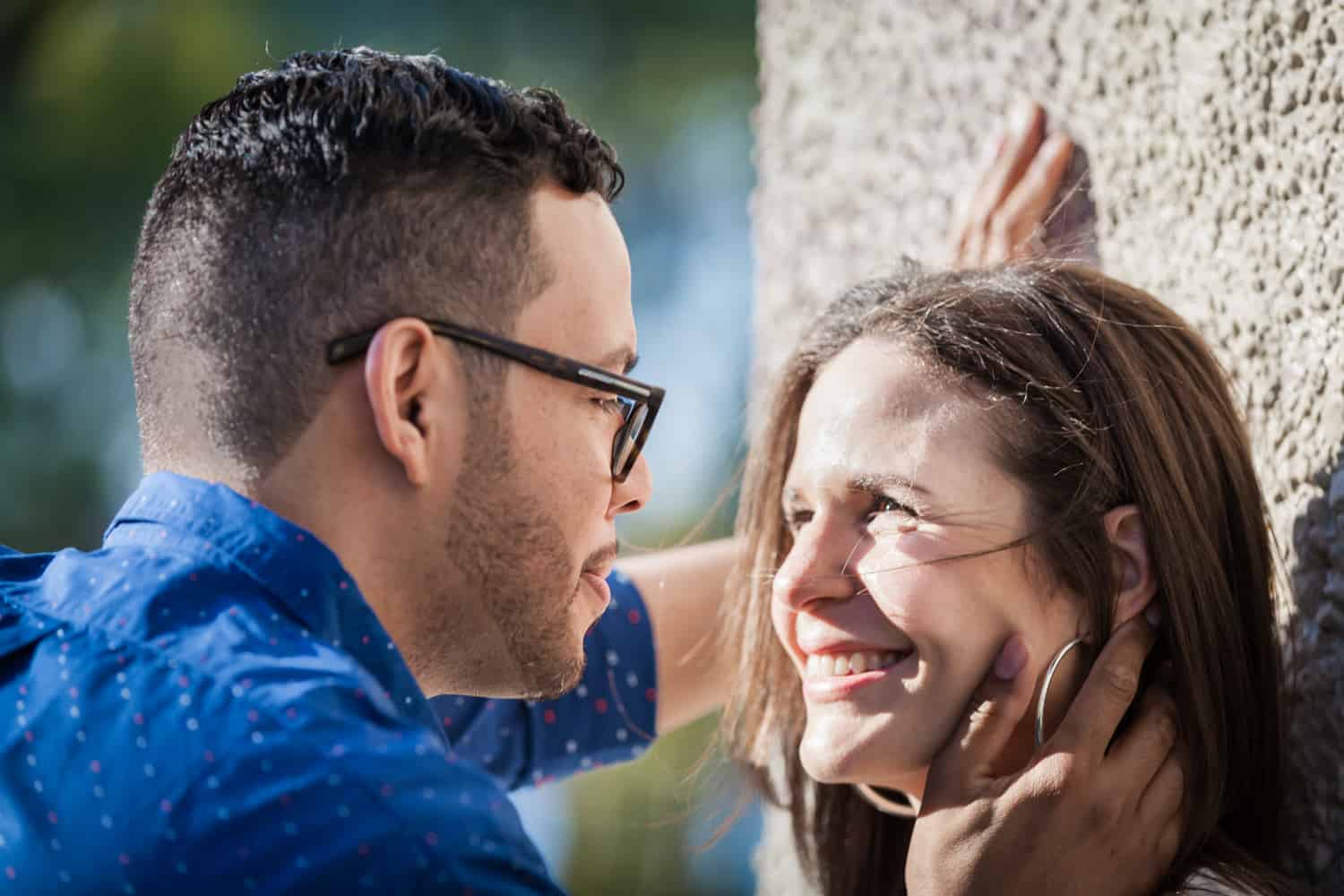 Man touching woman's face during an Astoria Park engagement shoot